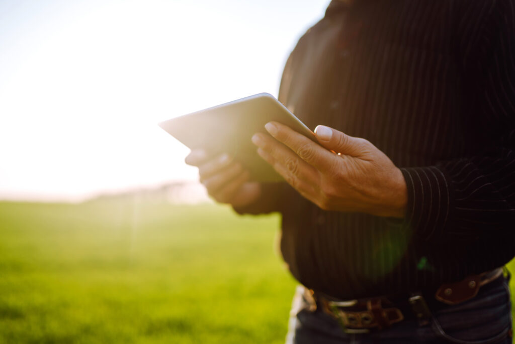 Farmer working on tablet in a field