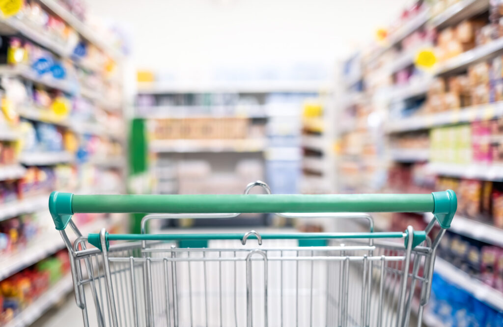 Shopping cart in supermarket aisle